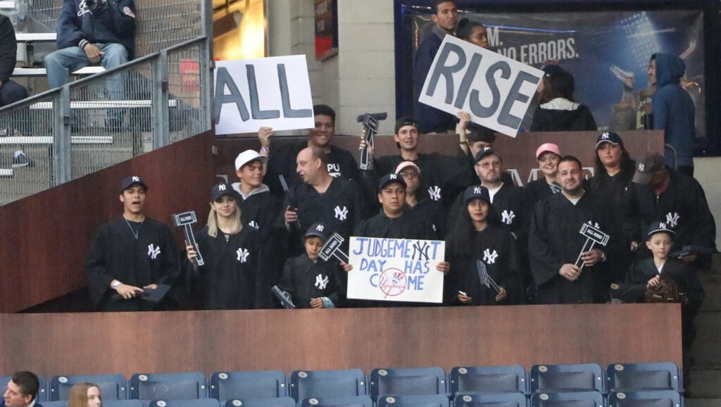 Fans at Yankee Stadium supporting Aaron Judge during a game.