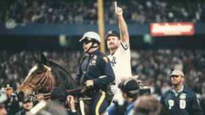 New York Yankees Wade Boggs rides a police horse around the field after the Yankees won 1996 World Series.