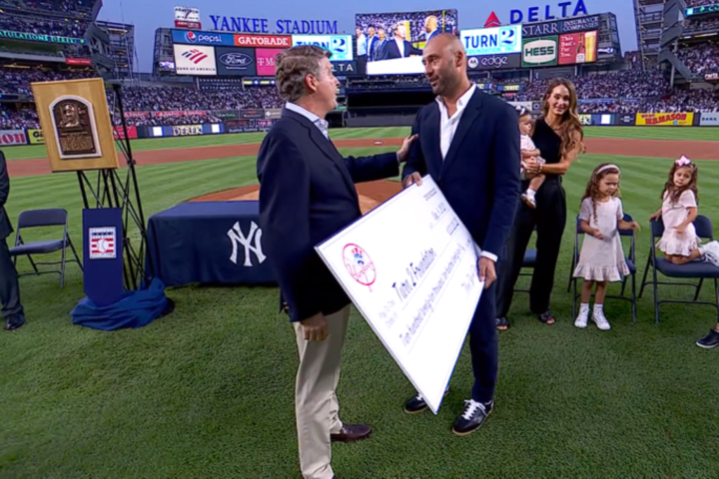 Yankees owner Hal Steinbrenner greets Derek Jeter during his Hall of Fame plaque introduction at Yankee Stadium.