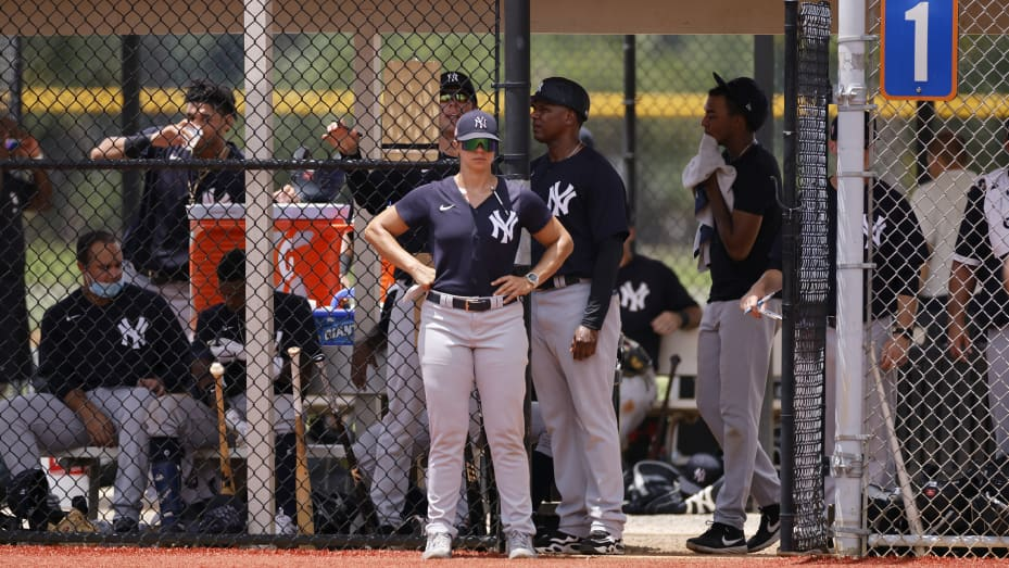 New York Yankees minor-league manager Rachel Balkovec looks at team players at a training camp.