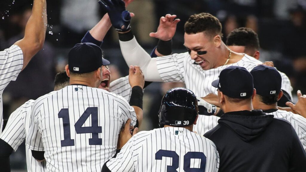 Aaron Judge celebrating with his Yankees teammates after a walk off home run against the Blue Jays