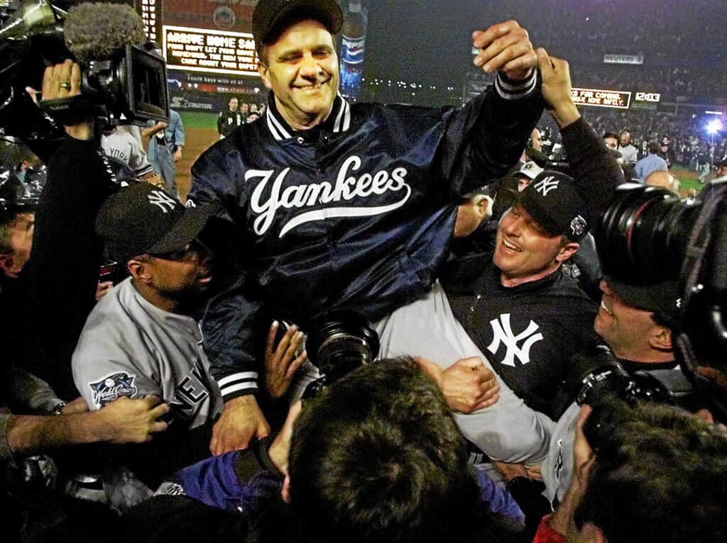 Joe Torre is carried by players on their shoulders after winning the 2000 subway series against the Mets.