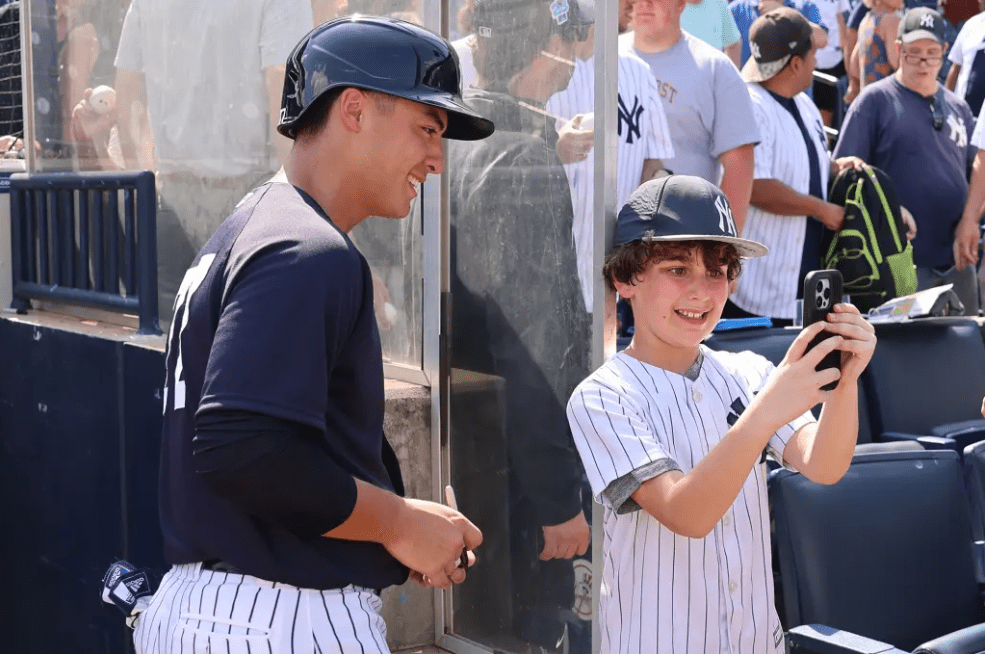 Anthony Volpe with a fan at Tampa, FL, Yankees spring training camp.