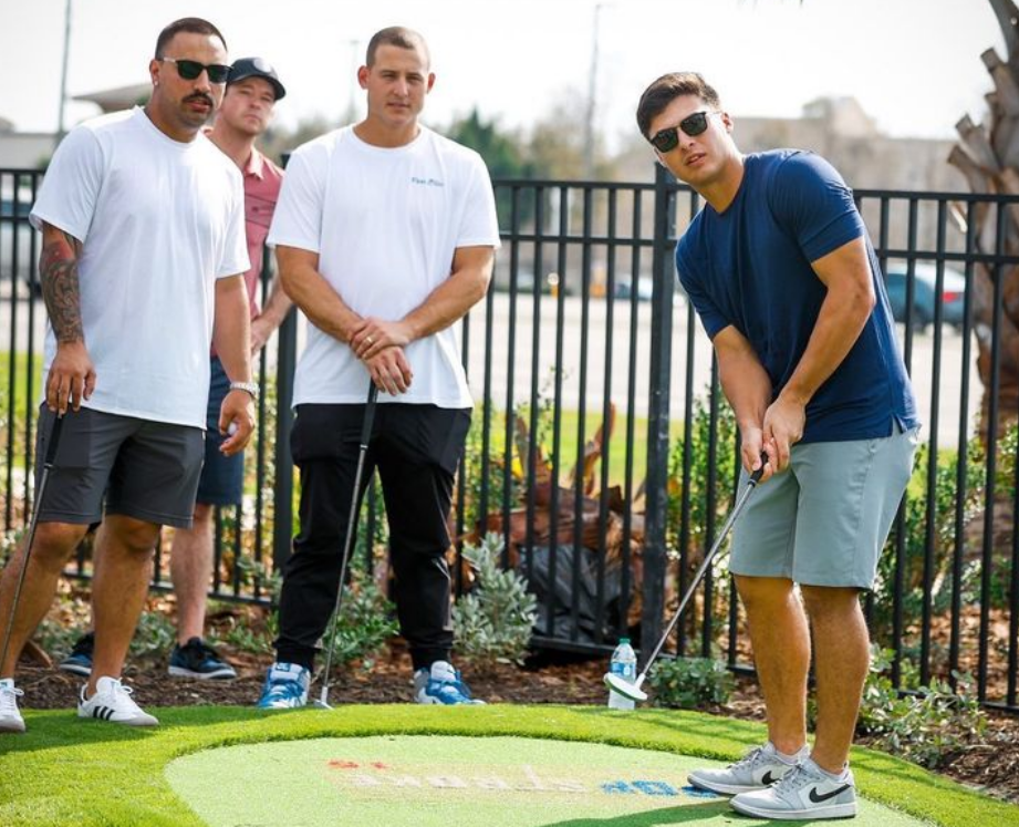 Anthony Volpe at the Yankees’ team-bonding mini golf tournament as Cortes and Rizzo observe him..