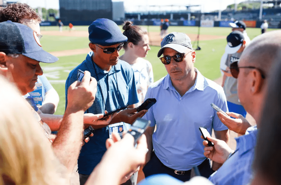 Brian Cashman is talking to reporters at Yankees spring training camp.