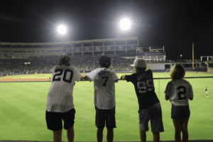 Four young Yankees fans are watching the team's spring training game against the Braves at George M. Steinbrenner Field on Feb 6, 2023.