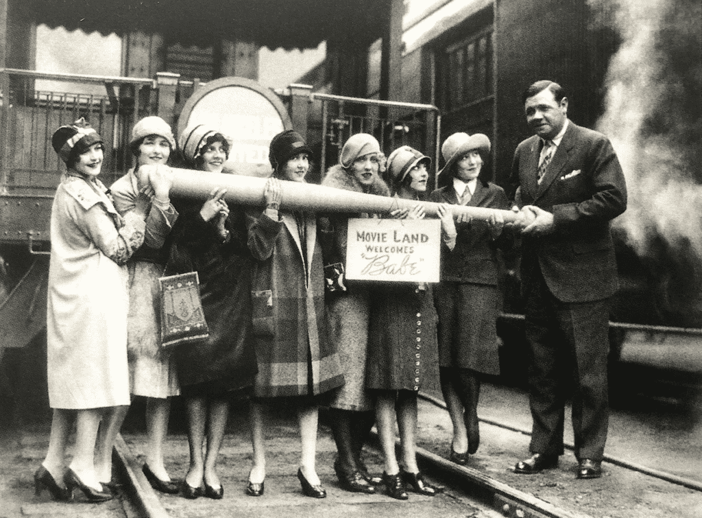 Babe Ruth is seen with ladies in New York with a big bat.