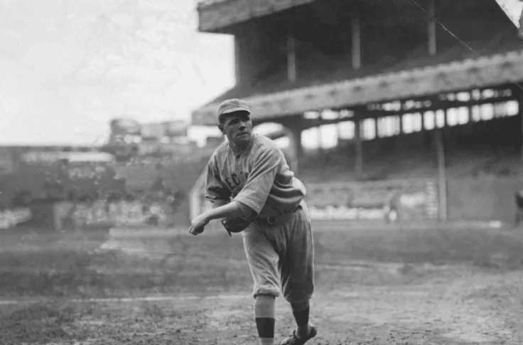 Babe Ruth is pitching while he was with the Boston Red Sox.