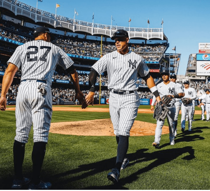 Aaron Judge leading the Yankees team to the dugout after an excellent performance against Philadelphia on Apr 5, 2023, at Yankee Stadium.