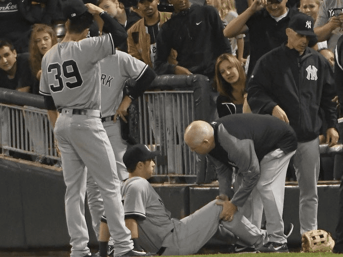 Yankees Jake Bauers suffers a knee injury after a jaw-dropping catch at Globe Life Field on April 30, 2023, against the Rangers.