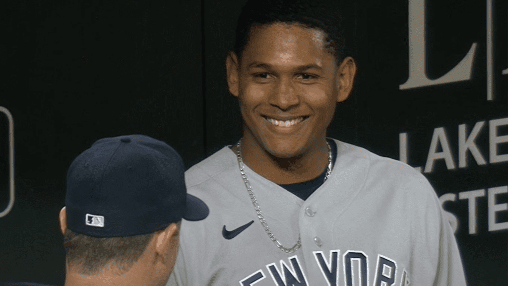 Jhony Brito smiles in Yankees dugout after his excellent second start in Baltimore on April 8, 2023.