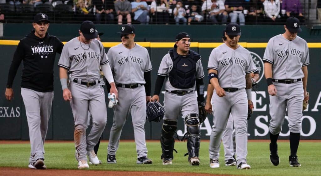 Yankees teammates are checking on Jake Bauers after he was injured while catching against the Rangers on April 30, 2023, at Globe Life Field.