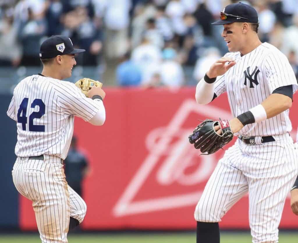 Yankees' Anthony Volpe is celebrating with Aaron Judge at Yankee Stadium after hitting his first home run on April 14, 2023, against the Twins.