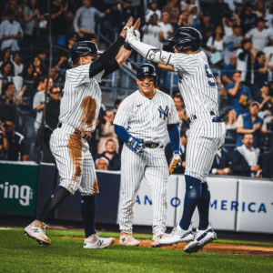 The Yankees are celebrating after a home run against the Athletics on May 8, 2023, at Yankee Stadium.