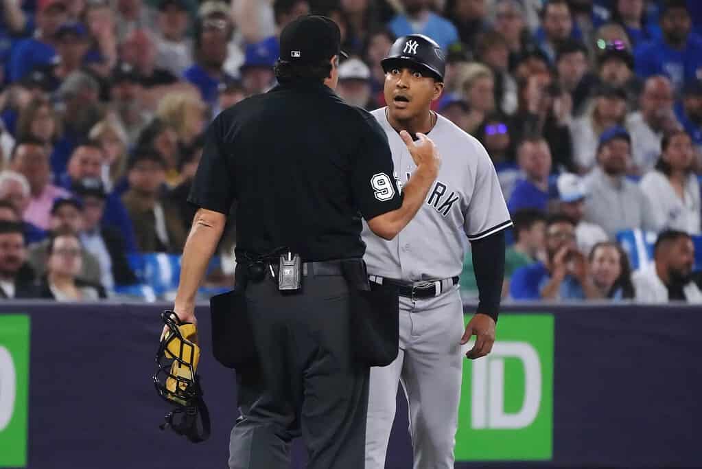 Yankees third-base coach Luis Rojas talking to umpire after Blue Jays targeted him on May 16, 2023, at Rogers Center, Toronto.