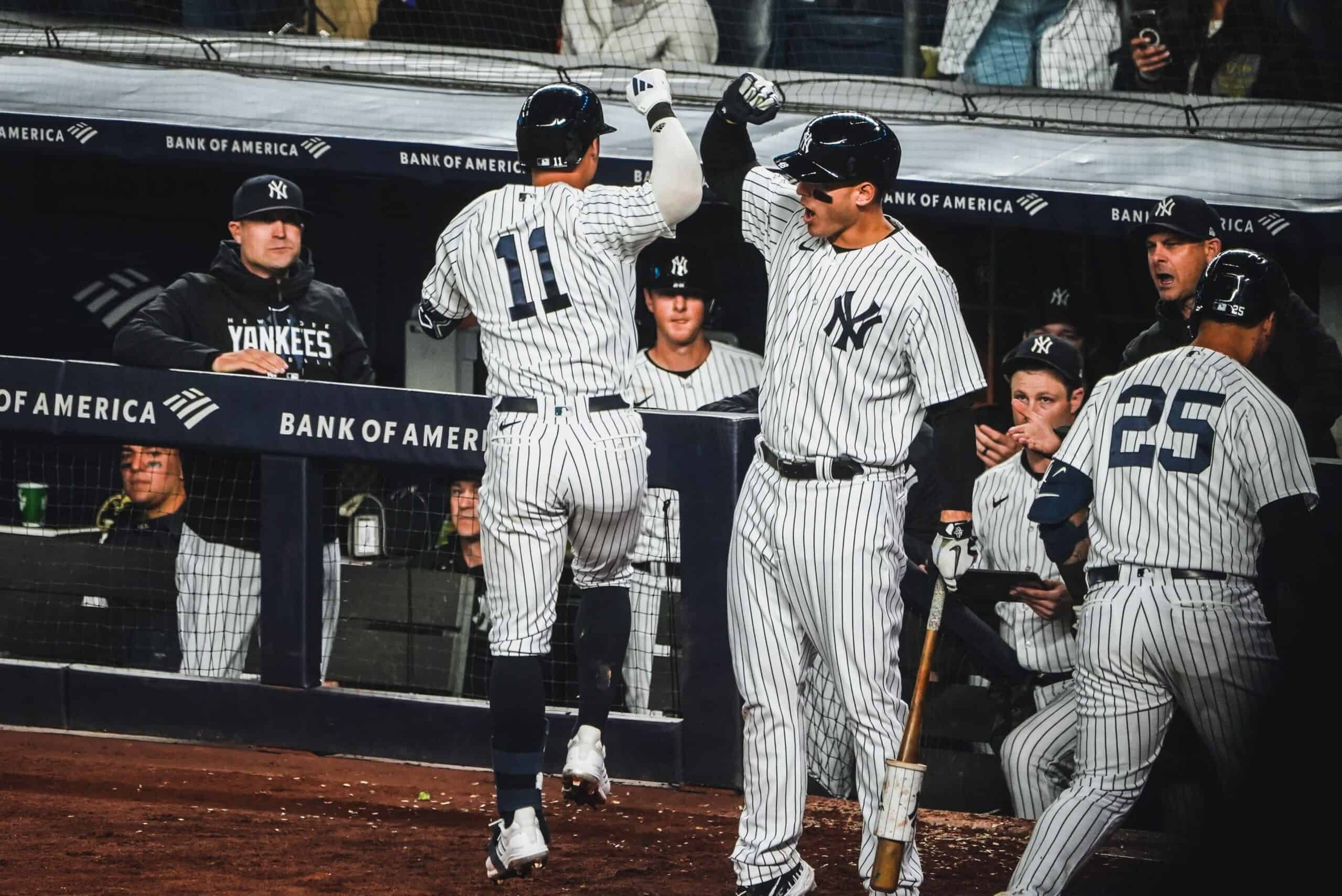 Yankees' Anthony Volpe and Anthony Rizzo are celebrating Volpe's home run against the Guardians on May 2, 2023, at Yankee Stadium.