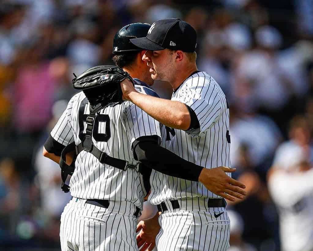 Yankees' pitcher Michael King hugs the catcher after his save against the Rangers on June 25, 2023, Yankee Stadium.