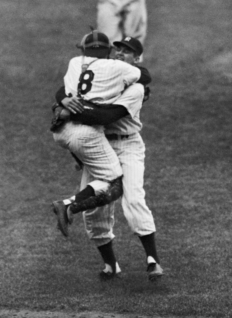 FILE - In this Oct. 8, 1956, file photo, New York Yankees catcher Yogi Berra leaps into the arms of pitcher Don Larsen after Larsen struck out the last Brooklyn Dodgers batter to complete his perfect game during Game 5 of the World Series in New York. Larsen, the journeyman pitcher who reached the heights of baseball glory in 1956 for the Yankees when he threw a perfect game and only no-hitter in World Series history, died Wednesday, Jan. 1, 2020. He was 90. 