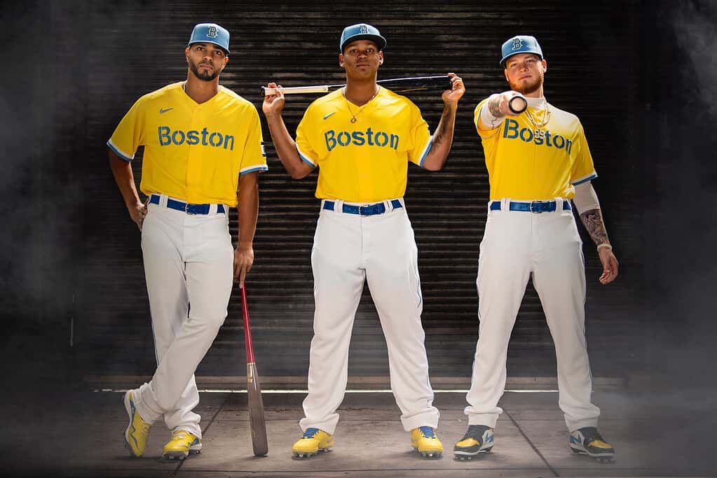 Boston Red Sox shortstop Xander Bogaerts, third baseman Rafael Devers, and outfielder Alex Verdugo pose for a portrait as they display 2021 Boston Red Sox Nike City Connect uniform at Fenway Park in Boston, Massachusetts Tuesday, April 6, 2021.