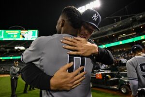 Aaron Judge hugs Domingo German after he pitched a perfect game against the A's on June 28, 2023, at Oakland.