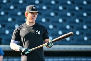 Yankees player Harrison Bader holding a bat at Yankees Stadium