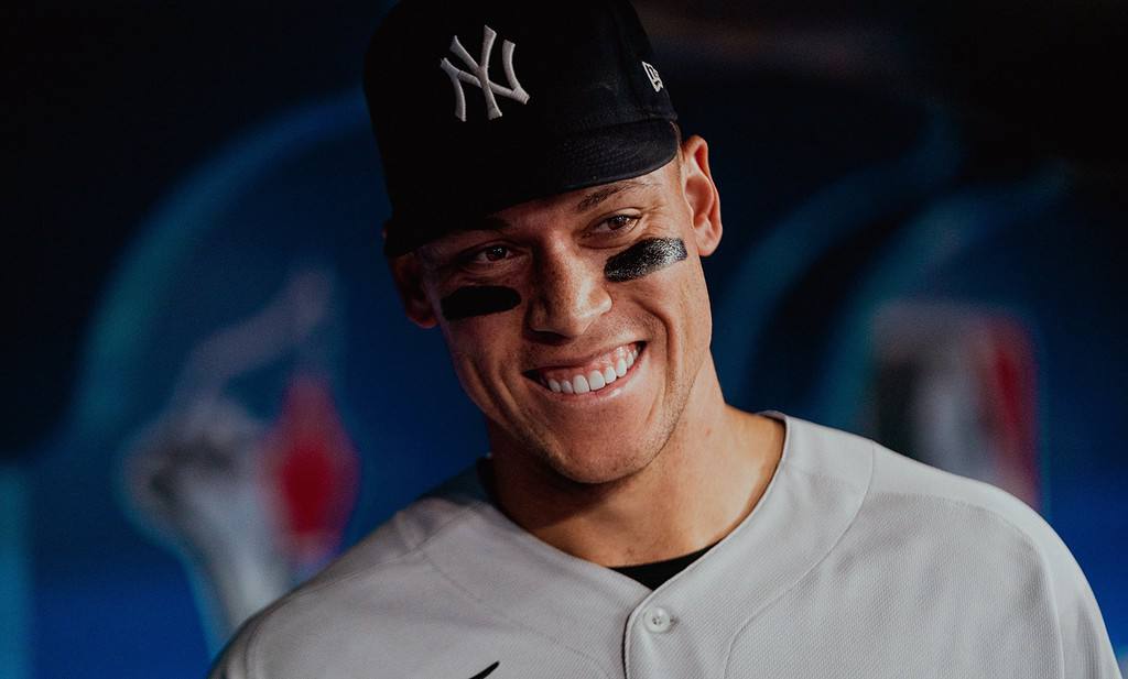 Aaron Judge smiling during a Yankees' game in MLB.