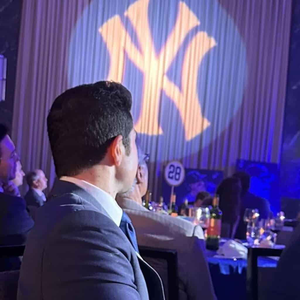 The Yankees logo is highlighted during an All-Star meet and reports Justin Shackil looks at it.