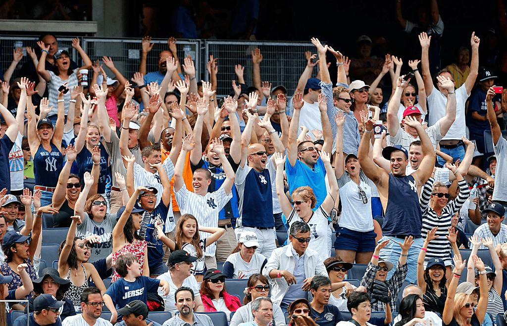 A section of Yankees fans are booing players at Yankee Stadium.