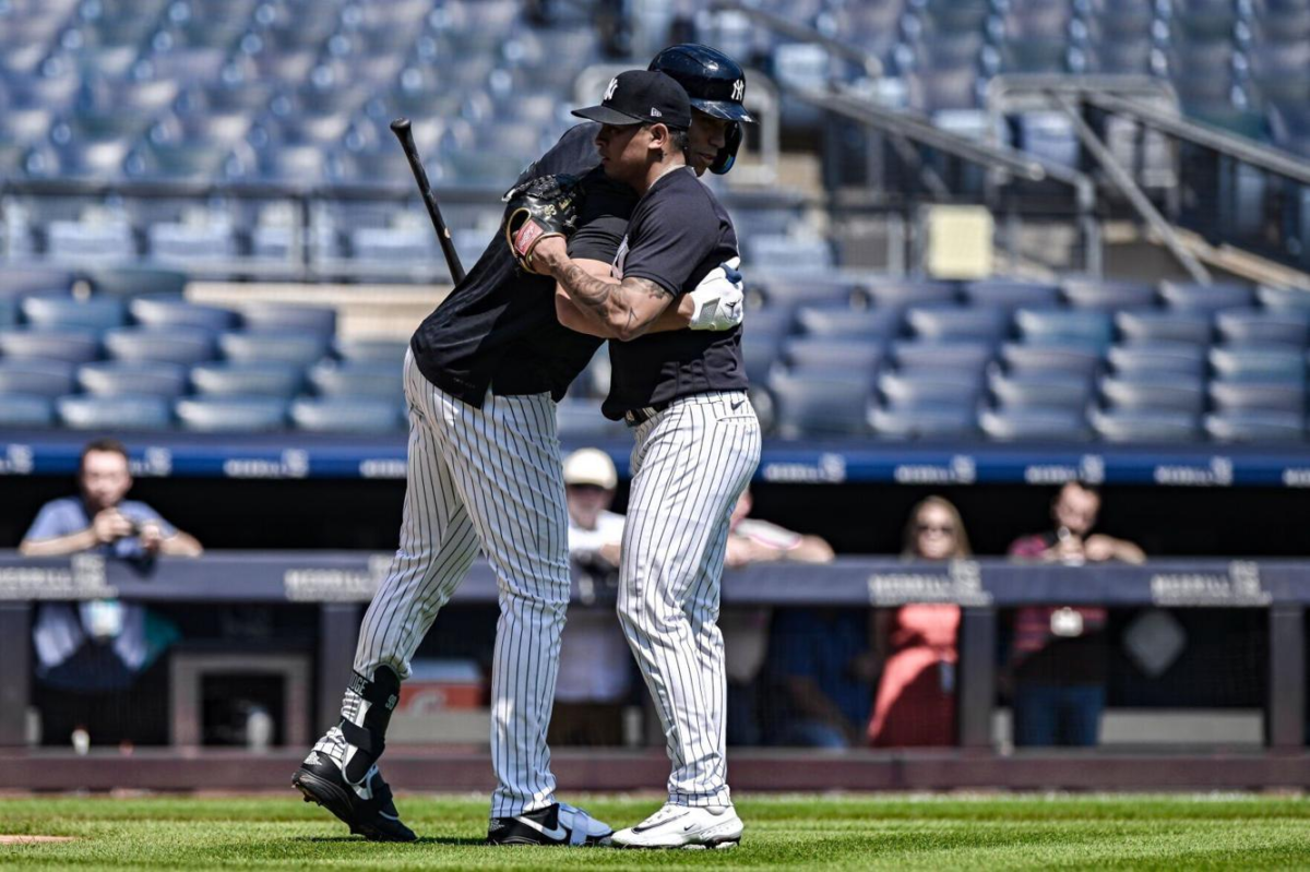 Aaron Judge and Yankees bullpen pitcher Jonathan Loaisiga, who are on IL, greet each other after their live practice session at Yankee Stadium on July 23, 2023.