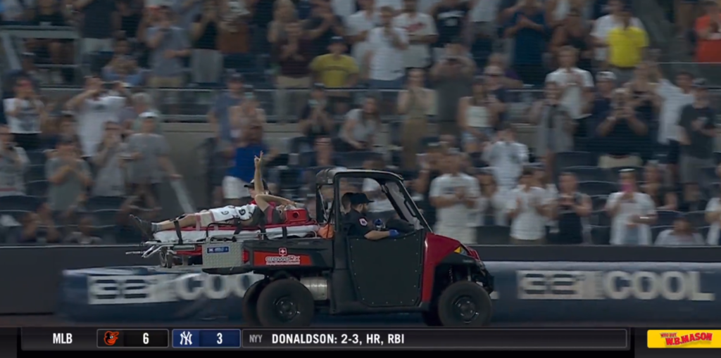 Cameraman Pete Stendel being carried on a stretcher during the Yankees vs. Orioles game.