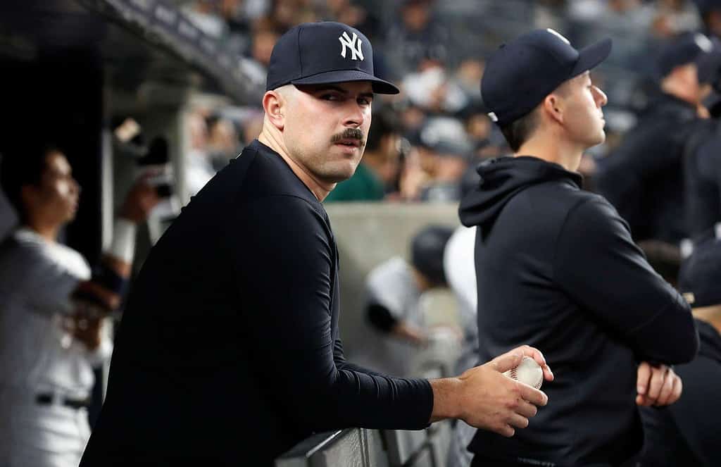 Carlos Rodon is with his teammates at the Yankees dugout.