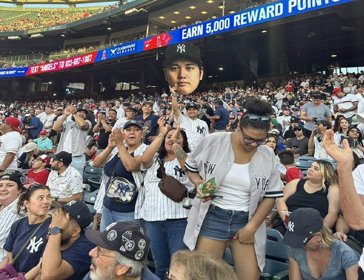 Yankees fans with a cutout of Shohei Ohtani at Yankee Stadium on July 18, 2023.