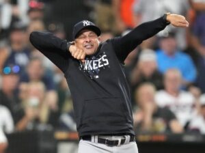 Aaron Boone is mimicking umpire Laz Diaz's actions before his ejection during the game against the White Sox on Aug 7, 2023, at Guaranteed Rate Field.