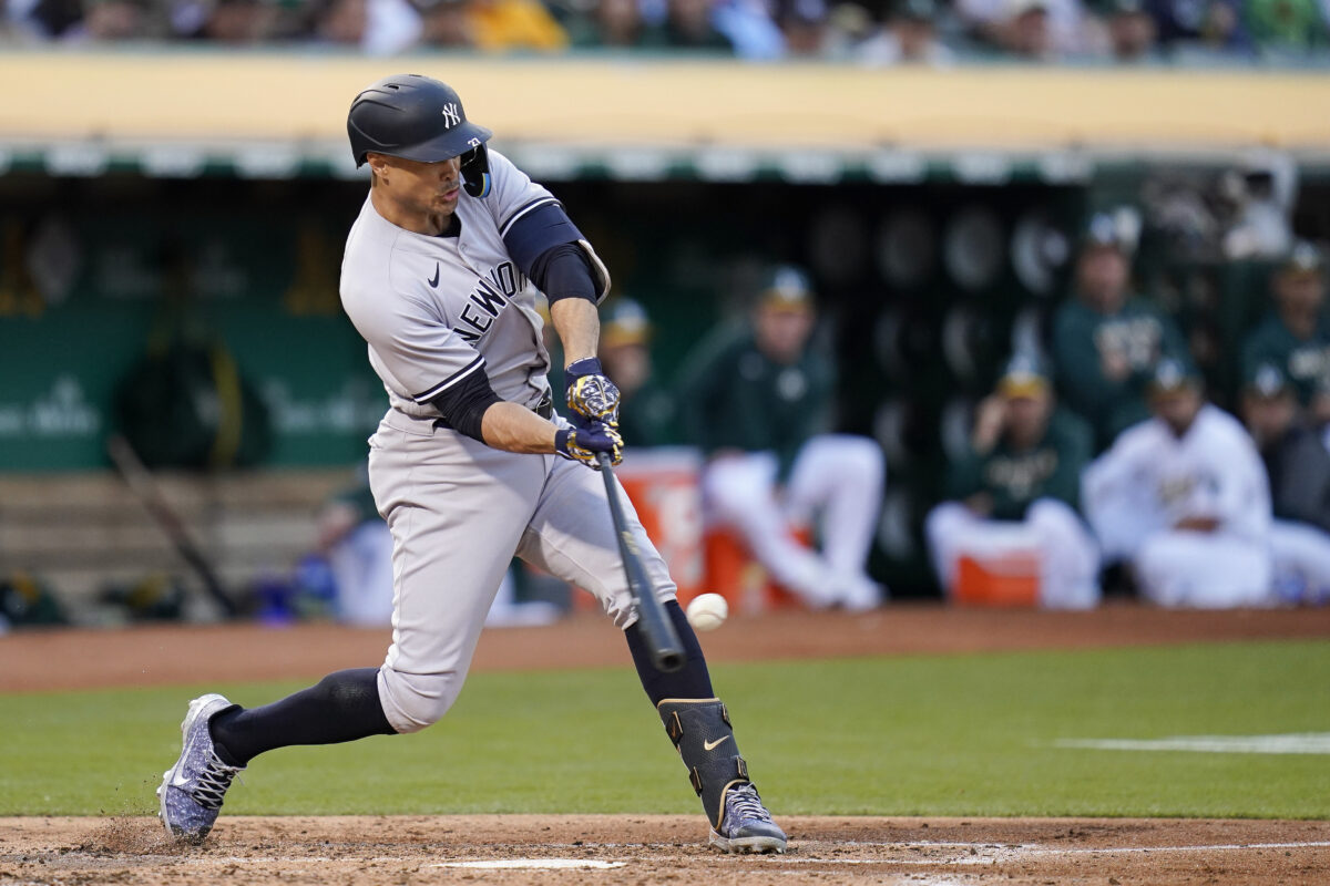 New York Yankees' Giancarlo Stanton hits a two-run single against the Oakland Athletics during the second inning of game in Oakland, Calif., Thursday, Aug. 25, 2022