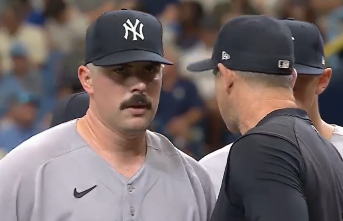 Yankees starter Carlos Rodon converses with Aaron Boone at the mound on Aug 27, 2023, at Tropicana Field.