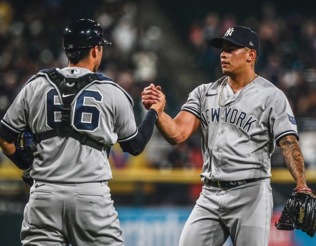 Yankees pitcher Jonathan celebrates victory over the White Sox with catcher Kyle Higashioka on August 8, 2023, in Chicago.
