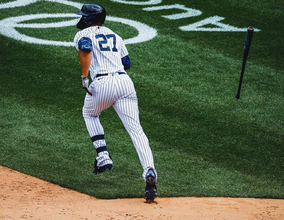 Yankees' Giancarlo Stanton runs to second base after a hit.