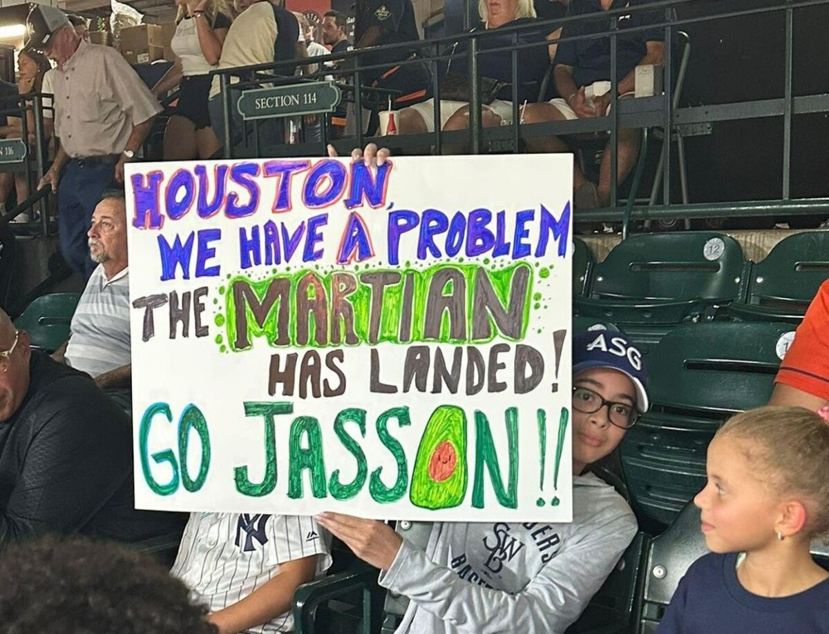 A fan holding a placard for Jasson Dominguez during his debut for the Yankees vs. the Astros in Houston on