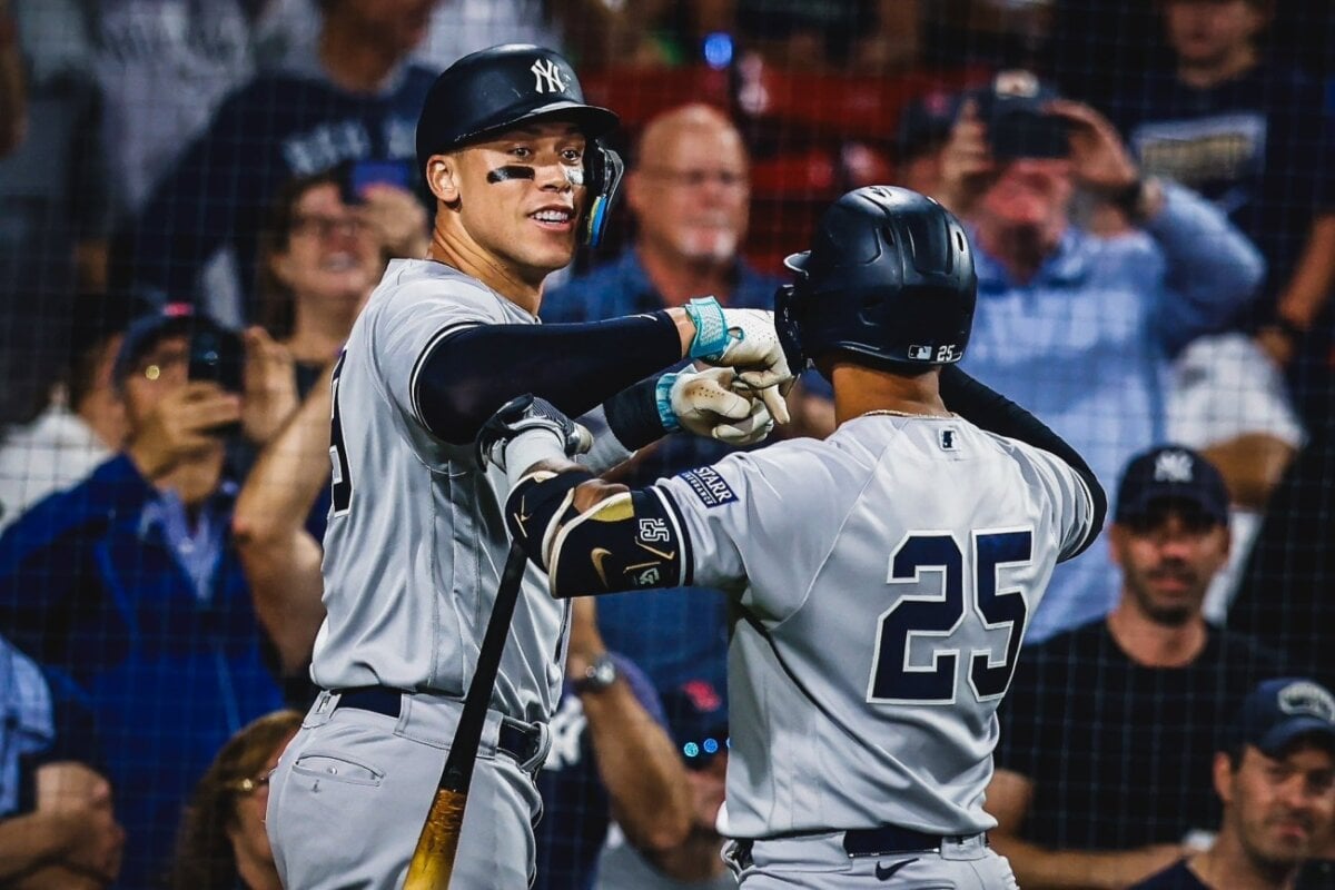 Aaron Judge celebrates with Torres after hitting a grand slam in Yankees vs. Red Sox game on Sept 14, 2023, at Fenway Park.
