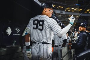 Aaron Judge celebrates in dugout after hitting three home runs against Arizona at Yankee Stadium on Sept 22, 2023.