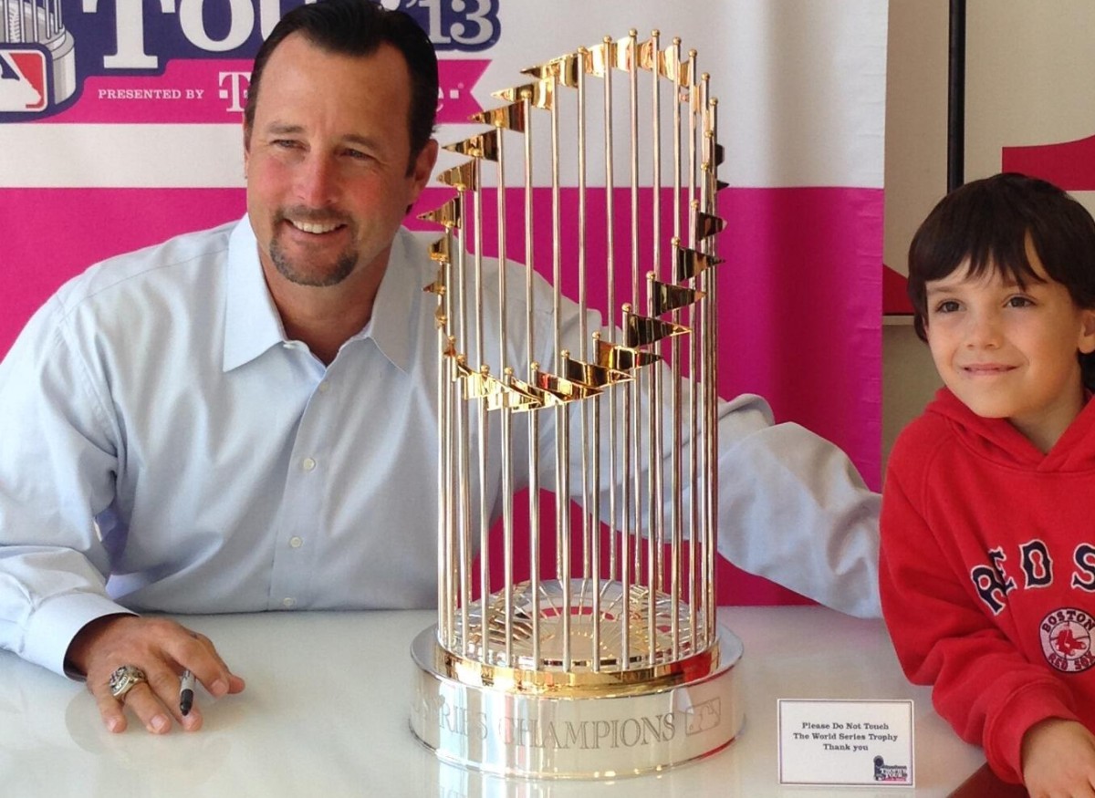 Tim Wakefield is with the Red Sox' 2013 World Series trophy at Fenway Park.