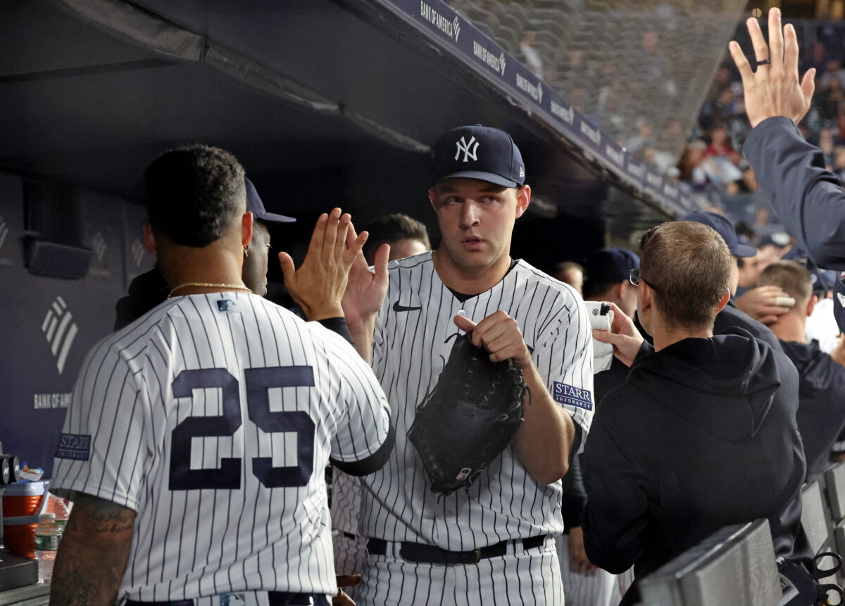New York Yankees pitcher Michael King (34) is greeted by New York Yankees second baseman Gleyber Torres (25) in the dugout after ending the 7th inning when the New York Yankees played the Toronto Blue Jays Wednesday, September 20, 2023 at Yankee Stadium in the Bronx, NY.