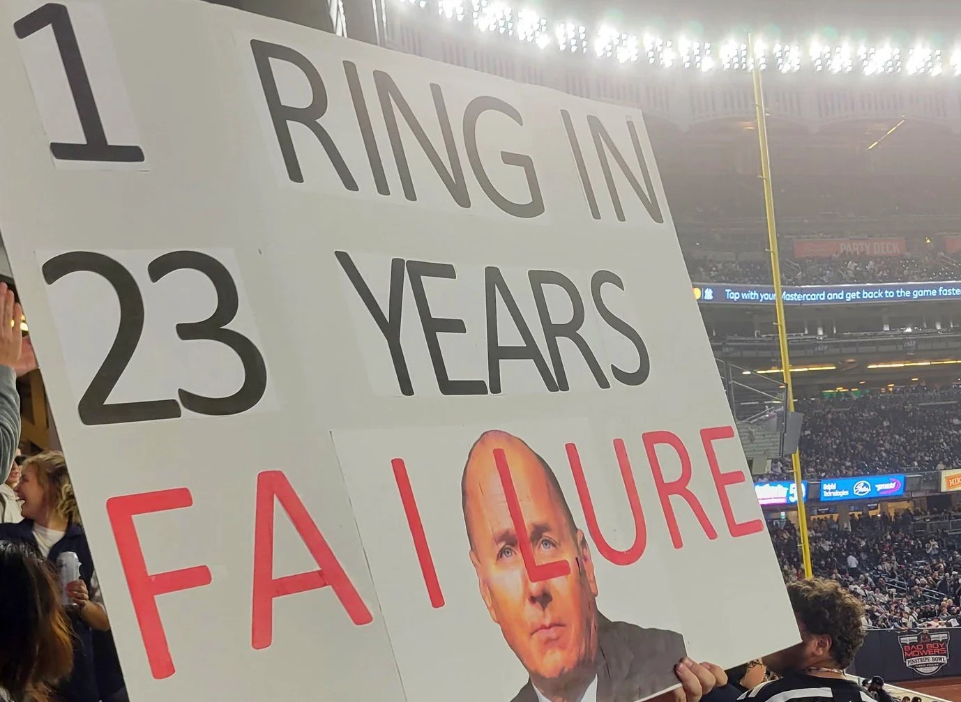 A fan with a poster during the 'Fire Cashman Night' on Sept. 22, 2023, at Yankee Stadium.