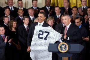 New York Yankees manager Joe Girardi presents President Barack Obama with a signed team jersey during a ceremony in the East Room of the White House to honor the 2009 World Series Champions.