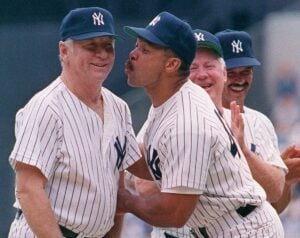 Yankees legends Reggie Jackson is with Mickey Mantle as Whitey Ford and Ron Guirdy look at them during an “Old Timer’s Day" at Yankee Stadium.