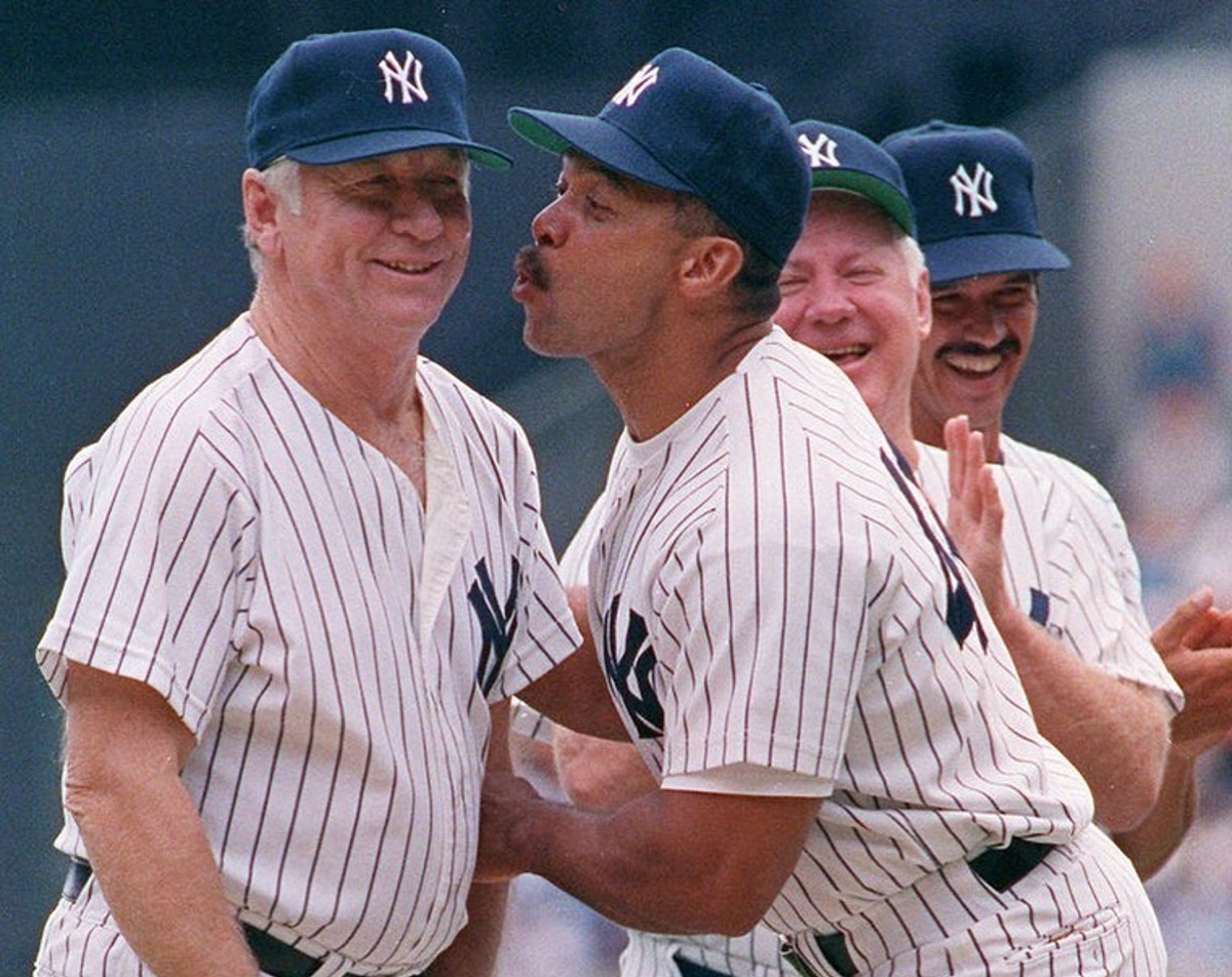 Yankees legends Reggie Jackson is with Mickey Mantle as Whitey Ford and Ron Guirdy look at them during an “Old Timer’s Day" at Yankee Stadium.