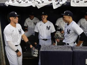 Aaron Judge, Anthony Rizzo, and Giancarlo Stanton at Yankees dugout in the Bronx.