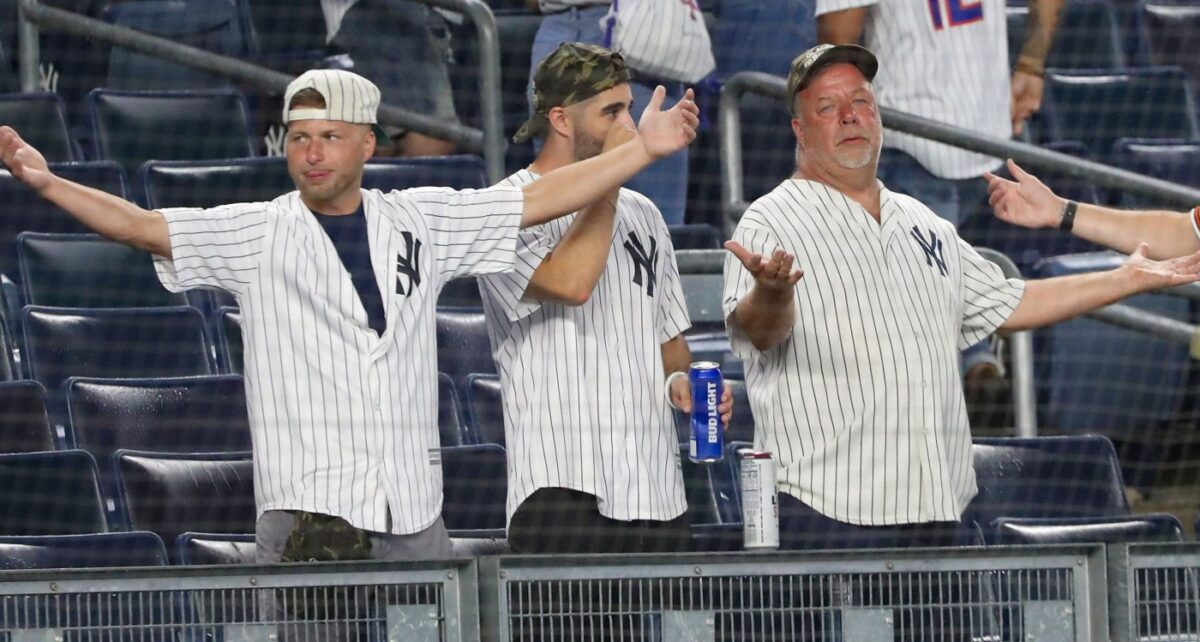 Fans react after the game between the Yankees and the Mets was postponed on July 2, 2021.