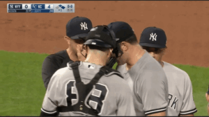 Yankees pitcher Carlos Rodon turns his back on his pitching coach Matt Blake in Kansas City on Sept. 29, 2023.