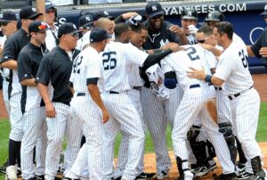 The 2011 New York Yankees teammates mob Derek Jeter after he achieved 3,000th career hit with a 400-foot home run at Yankee Stadium on July 9, 2011.